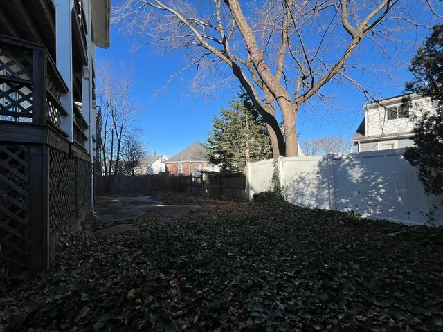 a view of a backyard with large trees