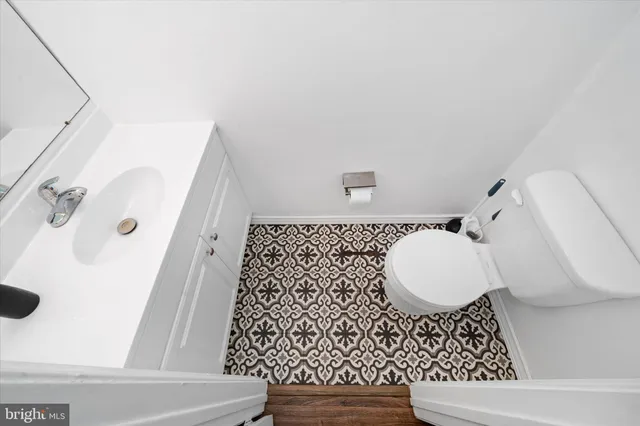 a bathroom with a sink a toilet and a mirror