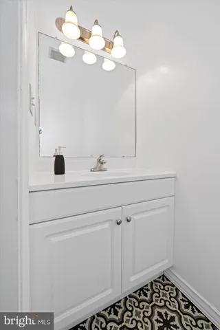 a bathroom with a sink a vanity and a mirror