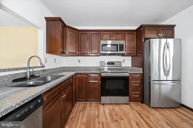 a kitchen with a sink stove and refrigerator