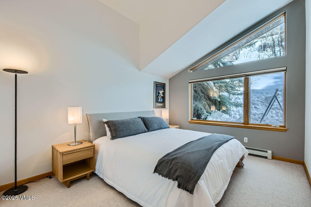 4173 Spruce Way Vail, CO 81657 - Photo 19 of 29 a bedroom with a bed and a window