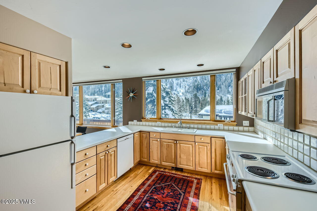 4173 Spruce Way Vail, CO 81657 - Photo 9 of 29 a kitchen with a stove a sink and a refrigerator