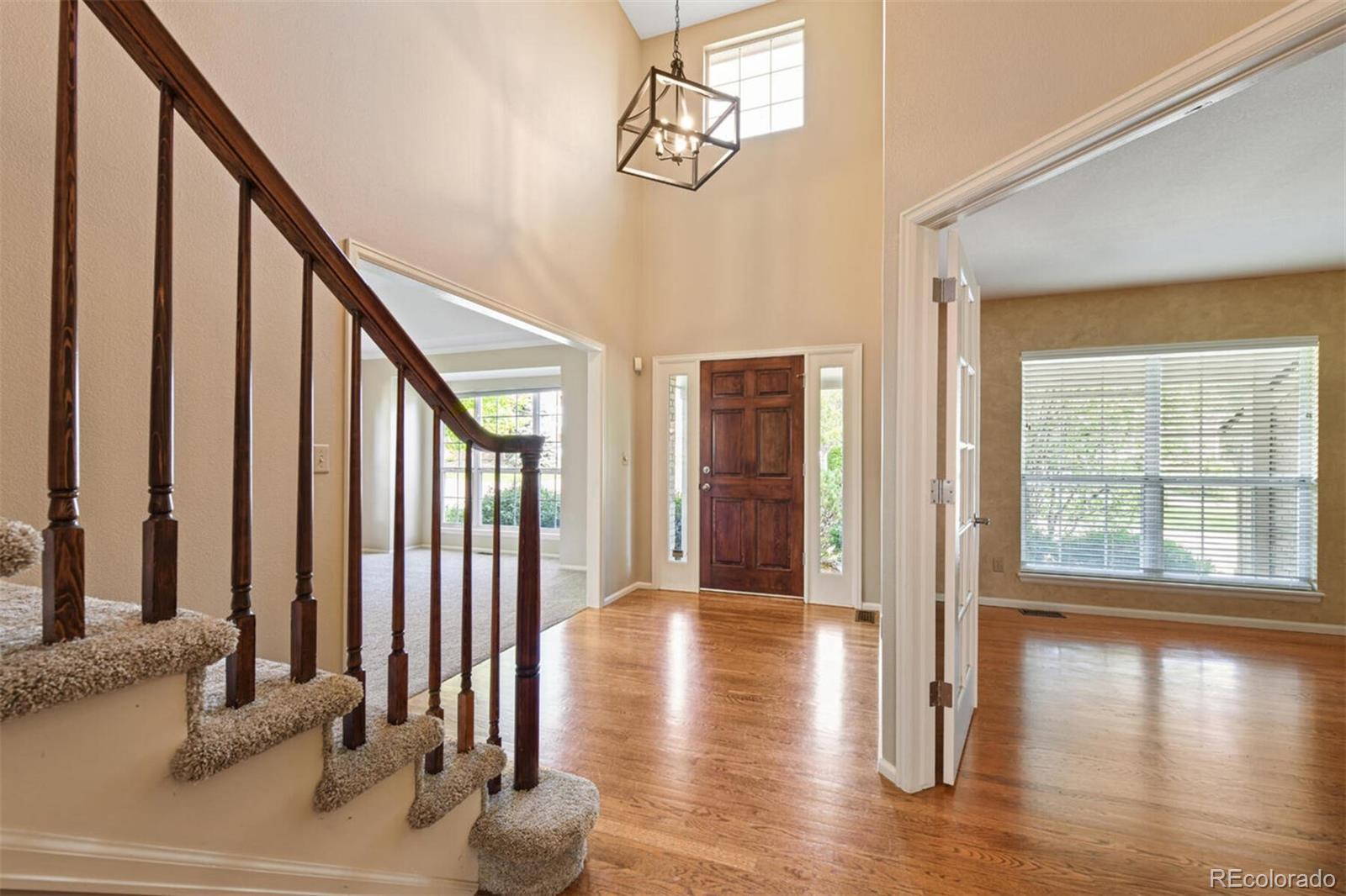 8581 Forrest Street Highlands Ranch, CO 80126 - Photo 3 of 40 a view of an entryway with wooden floor and door