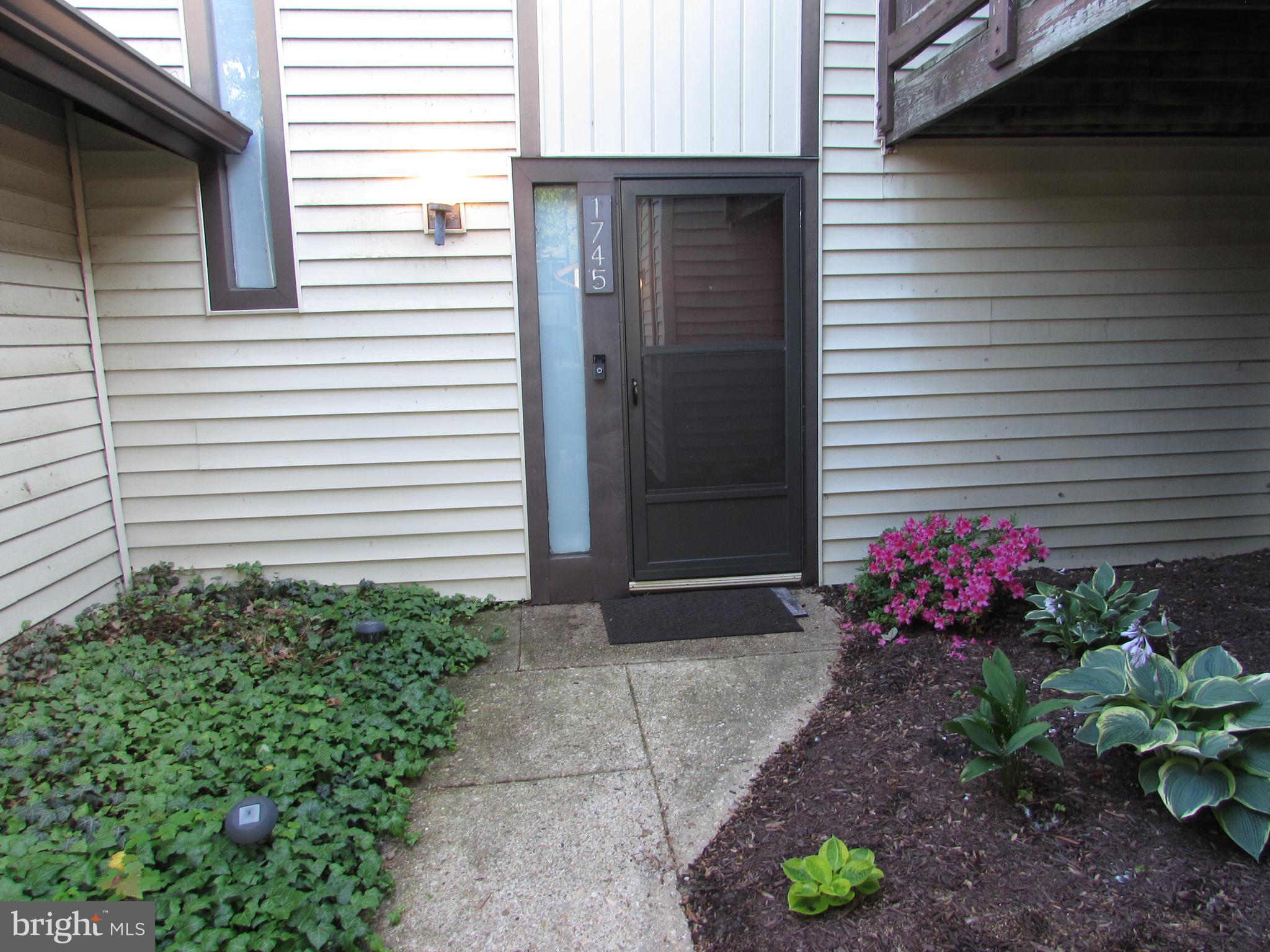 1745 Leisure Way Crofton, MD 21114 - Photo 1 of 14 a view of a potted plant sitting in front of a house