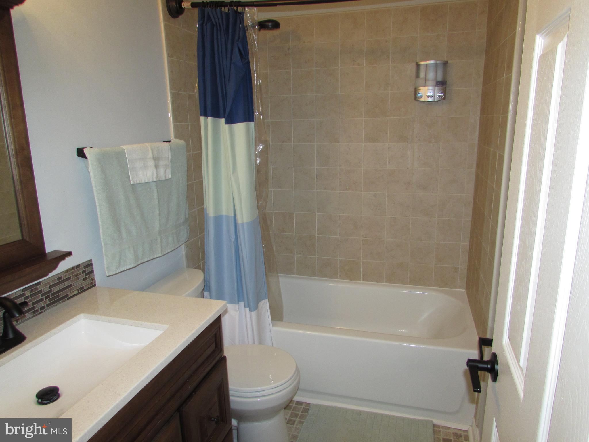 1745 Leisure Way Crofton, MD 21114 - Photo 14 of 14 a bathroom with a sink a toilet and shower