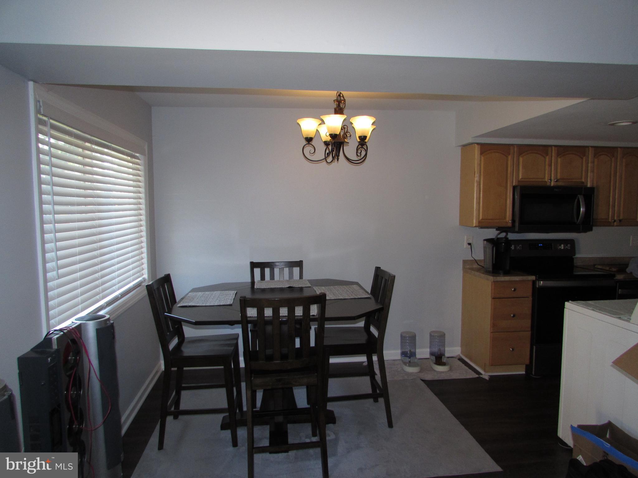 1745 Leisure Way Crofton, MD 21114 - Photo 6 of 14 a view of a dining room with furniture and wooden floor