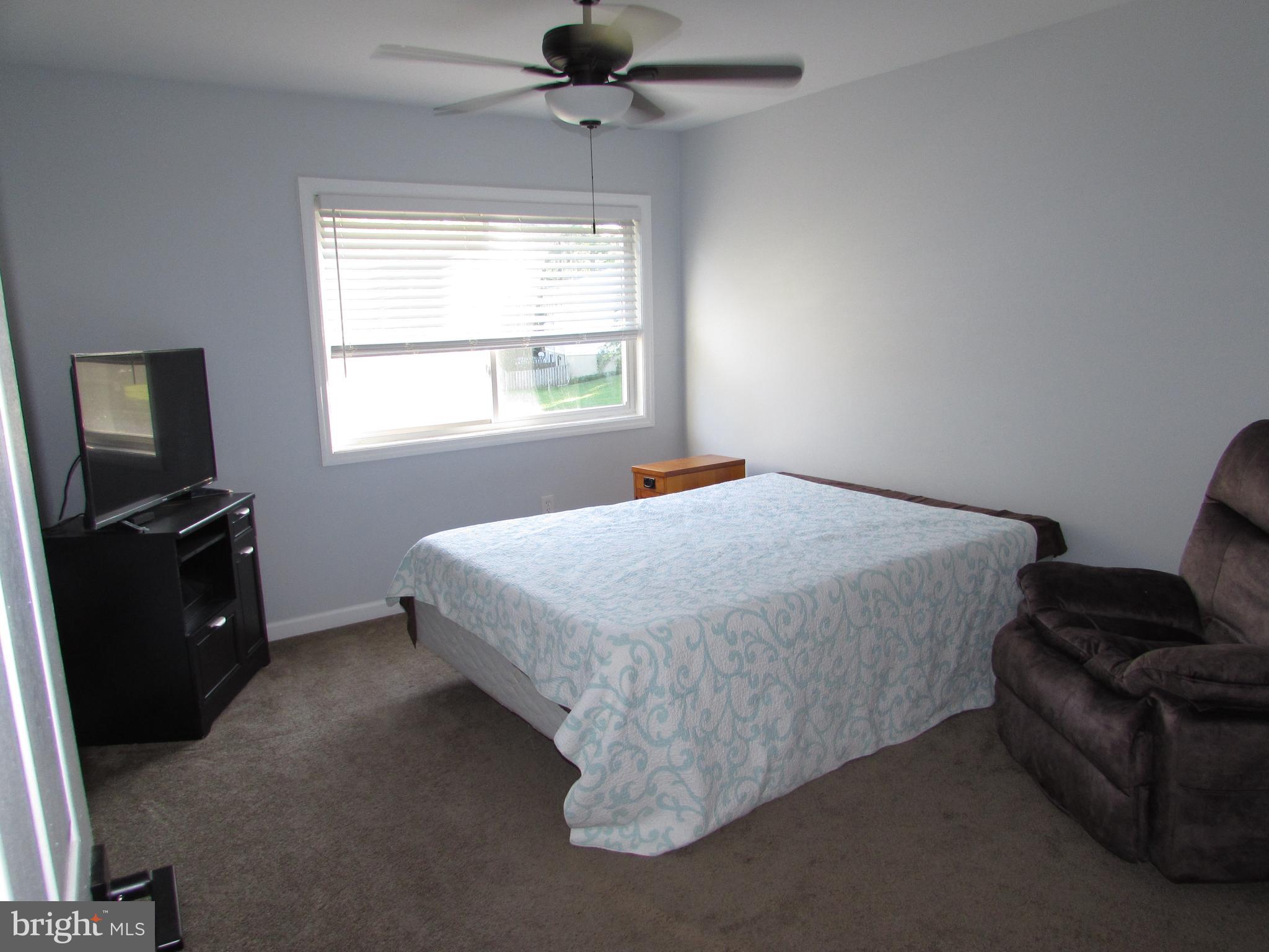 1745 Leisure Way Crofton, MD 21114 - Photo 9 of 14 a bed sitting in a bedroom next to a window