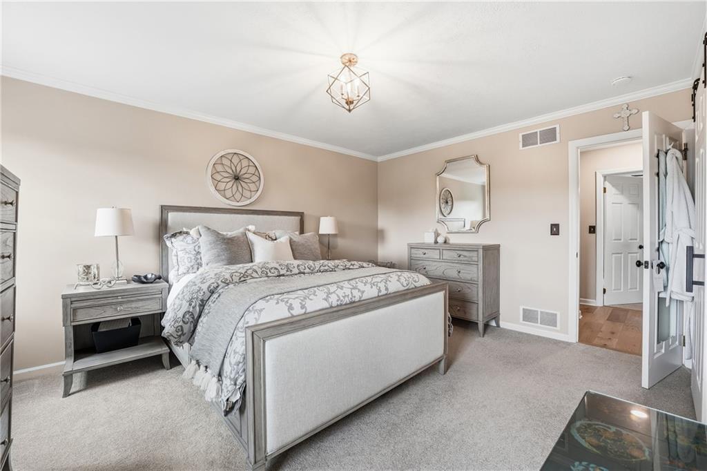 267 Forsythe Road Mars, PA 16046 - Photo 23 of 41 a bedroom with a bed and a chandelier