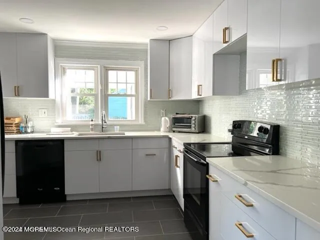 a kitchen with a sink cabinets and window
