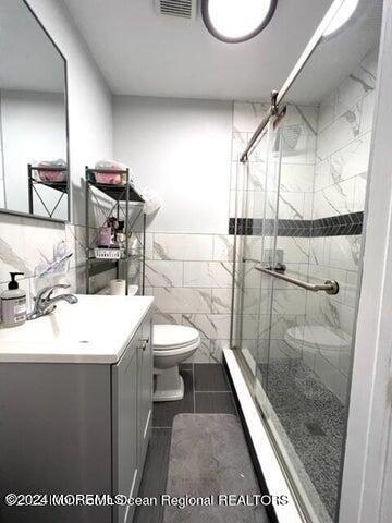 742 Myrtle Avenue West Allenhurst, NJ 07711 - Photo 5 of 13 a bathroom with a sink a toilet and shower