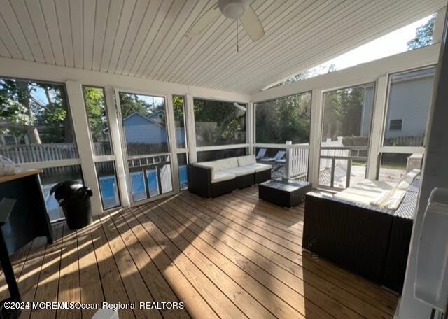 742 Myrtle Avenue West Allenhurst, NJ 07711 - Photo 10 of 13 a living room with furniture a flat screen tv and a floor to ceiling window