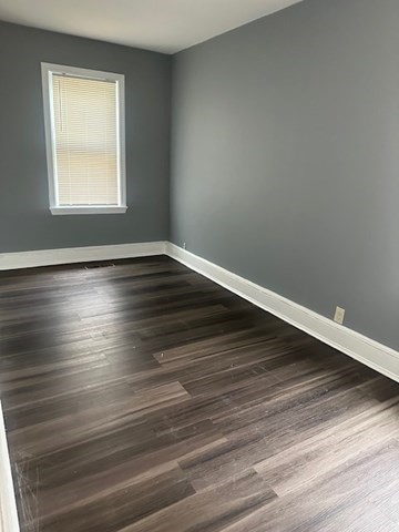 581 Lakeview Avenue, Unit 2 Lowell, MA 01850 - Photo 2 of 10 a view of an empty room with wooden floor and a window