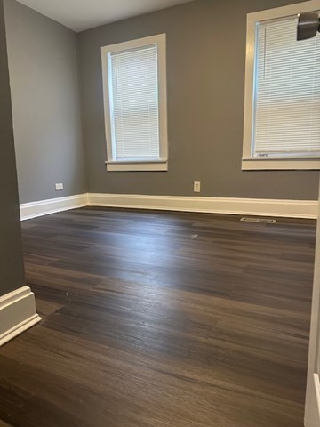 581 Lakeview Avenue, Unit 2 Lowell, MA 01850 - Photo 3 of 10 an empty room with wooden floor and windows