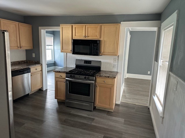 581 Lakeview Avenue, Unit 2 Lowell, MA 01850 - Photo 8 of 10 a kitchen with stainless steel appliances a stove a microwave and cabinets