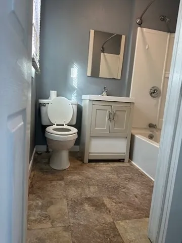 a bathroom with a toilet sink and shower