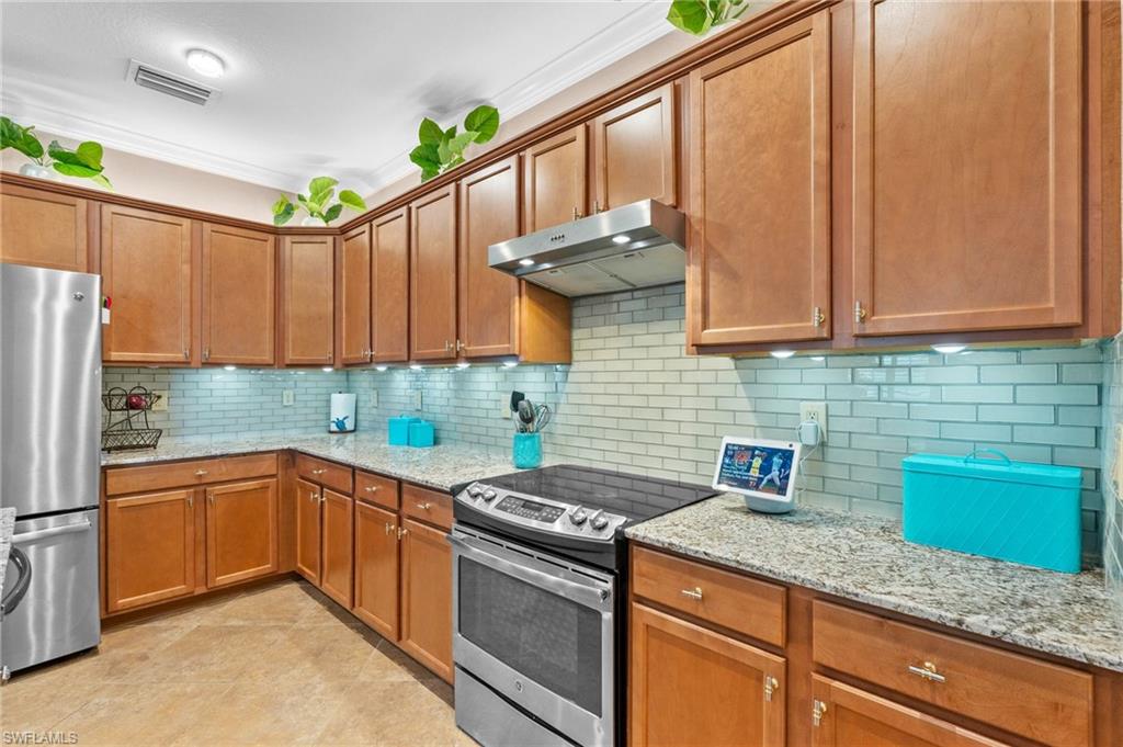 3147 Walnut Grove Lane Alva, FL 33920 - Photo 12 of 45 a kitchen with stainless steel appliances granite countertop a sink a stove and a refrigerator