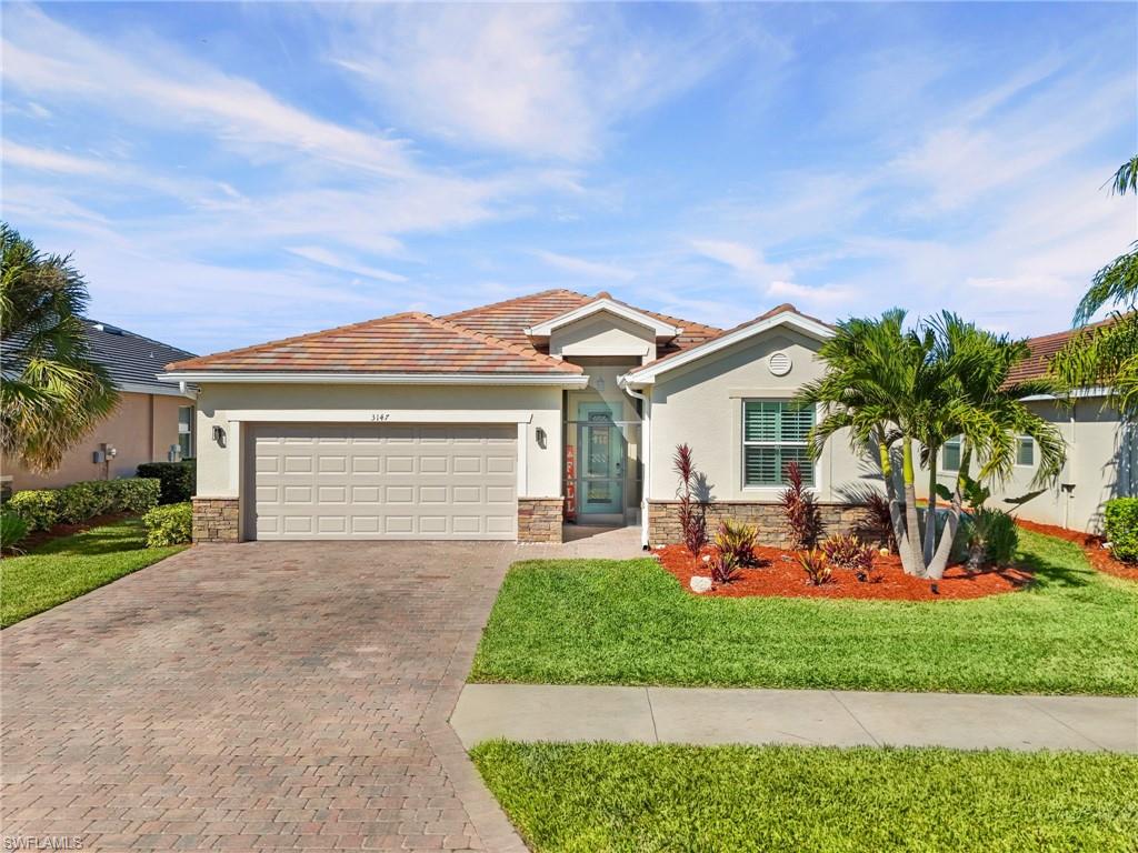 3147 Walnut Grove Lane Alva, FL 33920 - Photo 2 of 45 front view of a house with a yard