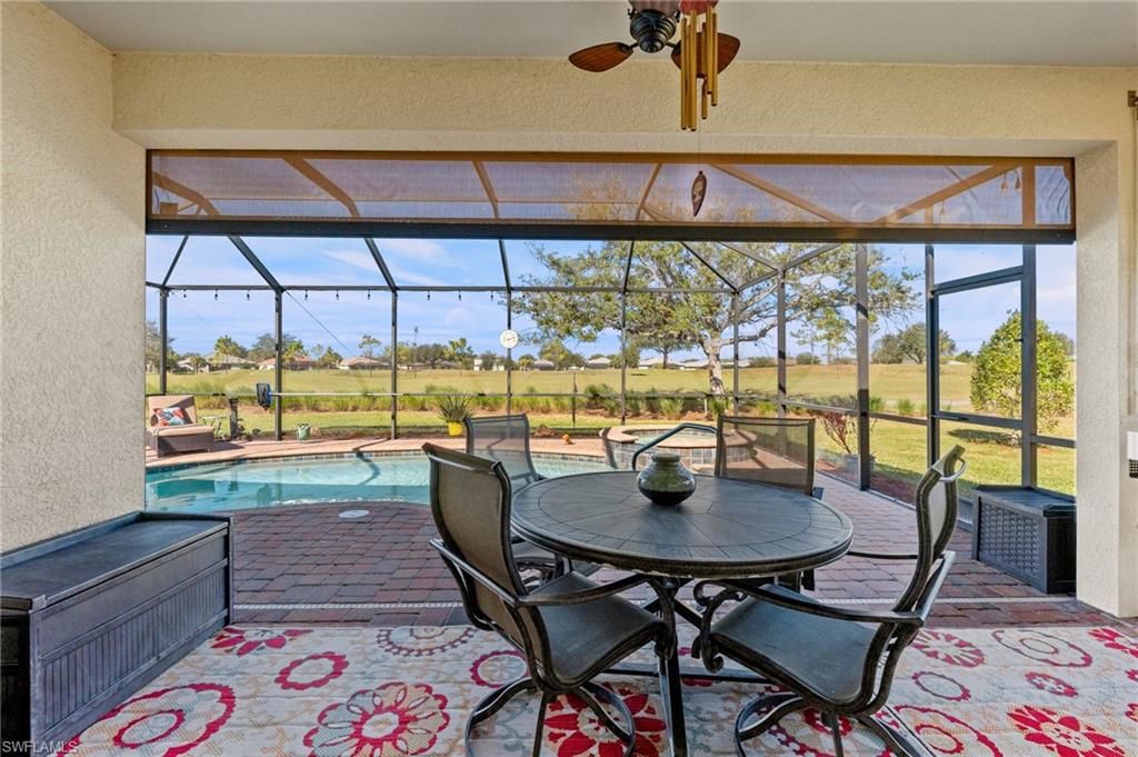 3147 Walnut Grove Lane Alva, FL 33920 - Photo 33 of 45 a dining room with furniture and a floor to ceiling window
