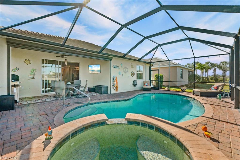 3147 Walnut Grove Lane Alva, FL 33920 - Photo 40 of 45 a swimming pool with outdoor seating