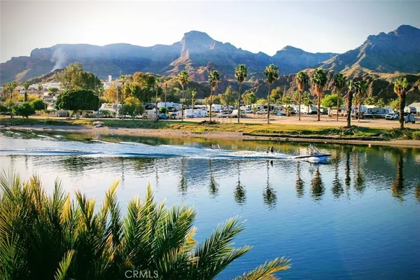 a view of swimming pool with outdoor seating and lake view