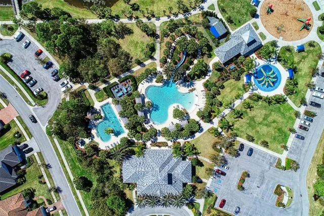 an aerial view of a house with swimming pool and ocean view
