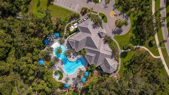 an aerial view of a house with a swimming pool outdoor seating and yard