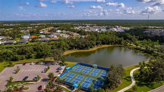 a living room with furniture a flat screen tv and a refrigerator