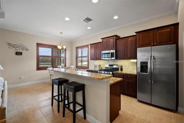 a living room with furniture and a view of kitchen