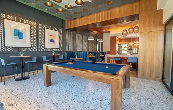 a room with pool table and windows