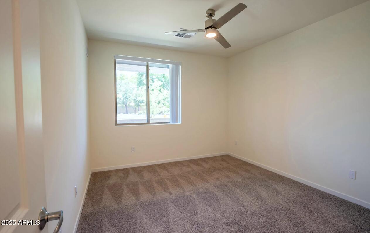 2050 West Southern Avenue, Unit 2 Phoenix, AZ 85041 - Photo 6 of 15 an empty room with a window
