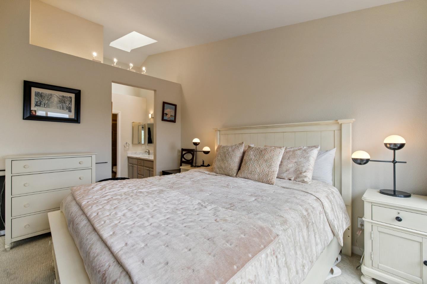 6 Patrick Way Half Moon Bay, CA 94019 - Photo 16 of 28 a bedroom with a bed and a lamp on dresser