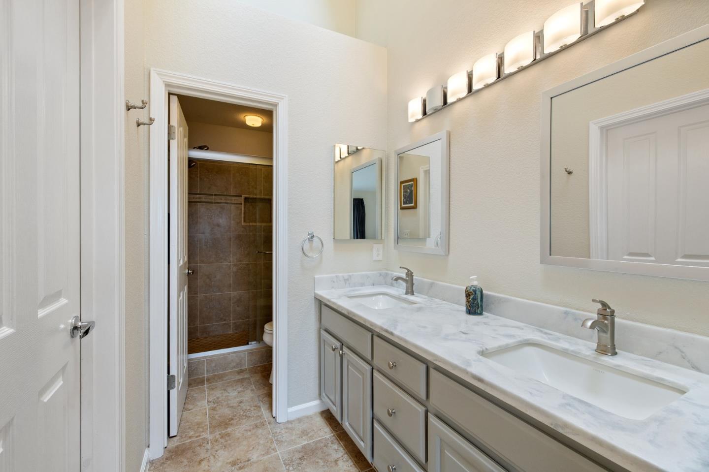 6 Patrick Way Half Moon Bay, CA 94019 - Photo 17 of 28 a bathroom with a granite countertop sink and a mirror