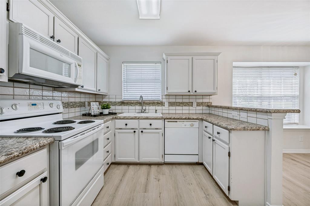 629 Concho Drive Oak Point, TX 75068 - Photo 11 of 35 a white kitchen with granite countertop stainless steel appliances