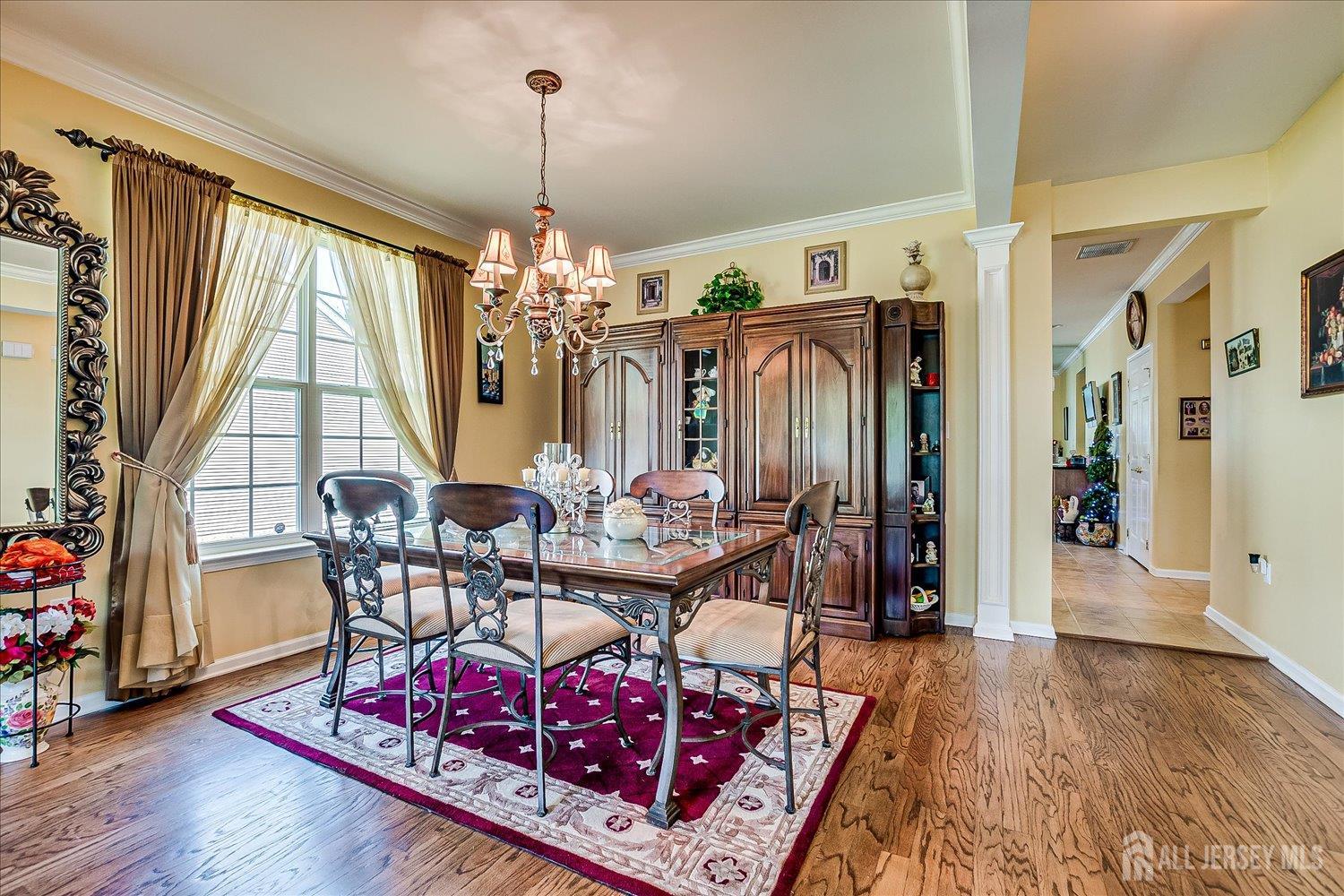 22 Silver Charm Road Manalapan, NJ 07726 - Photo 11 of 51 a view of a dining room with furniture window and wooden floor