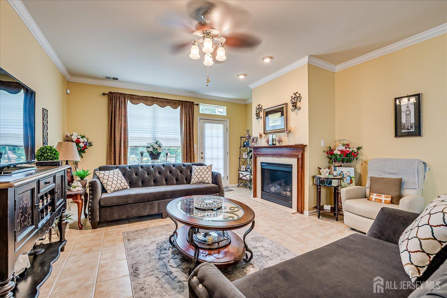 22 Silver Charm Road Manalapan, NJ 07726 - Photo 19 of 51 a living room with furniture a window and a fireplace