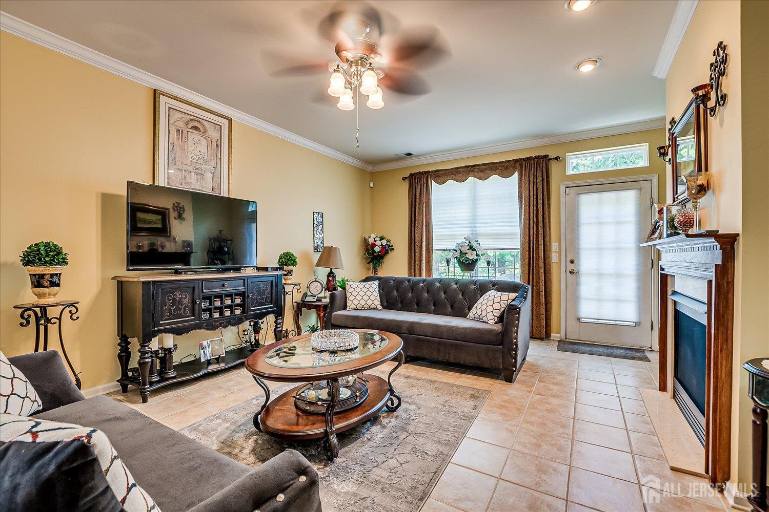 22 Silver Charm Road Manalapan, NJ 07726 - Photo 21 of 51 a living room with fireplace furniture and a flat screen tv