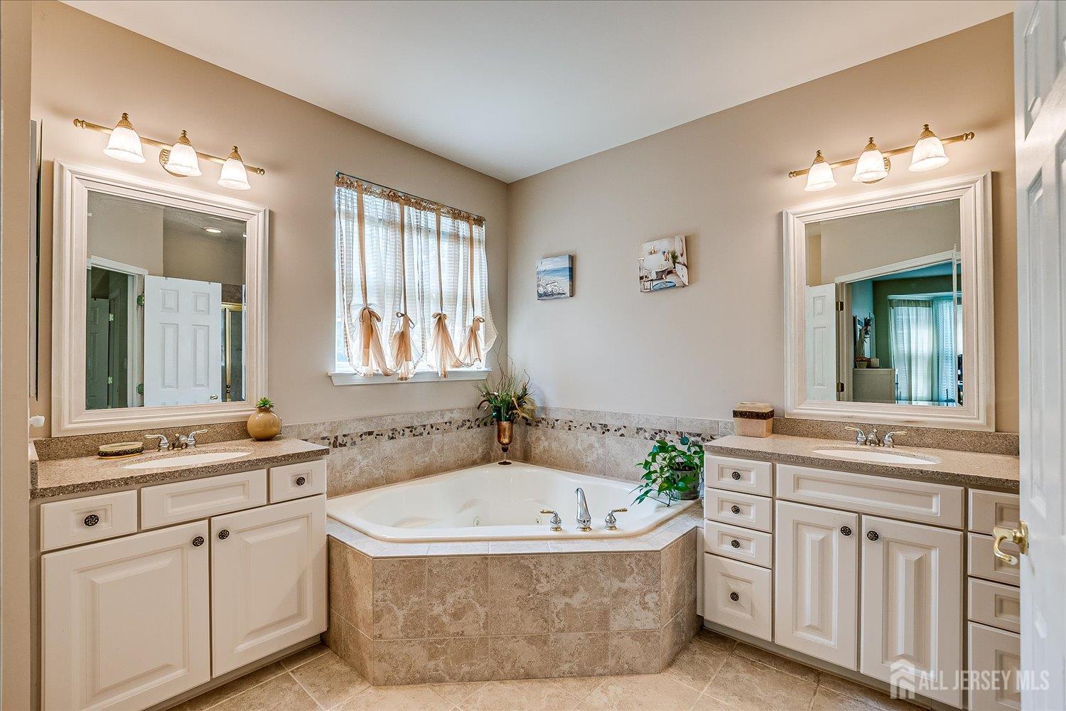 22 Silver Charm Road Manalapan, NJ 07726 - Photo 25 of 51 a bathroom with a granite countertop tub sink and mirror