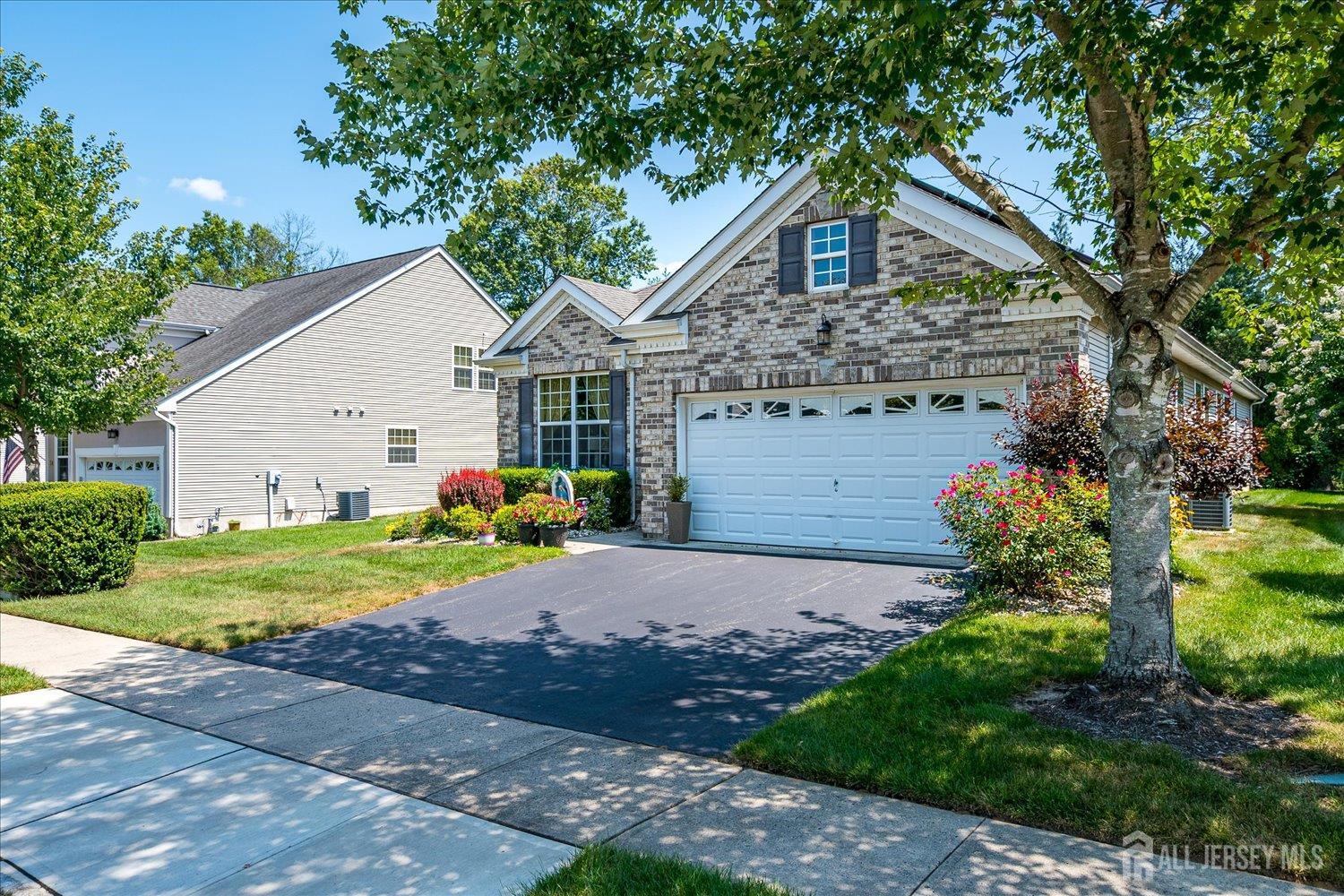 22 Silver Charm Road Manalapan, NJ 07726 - Photo 3 of 51 a front view of a house with garden