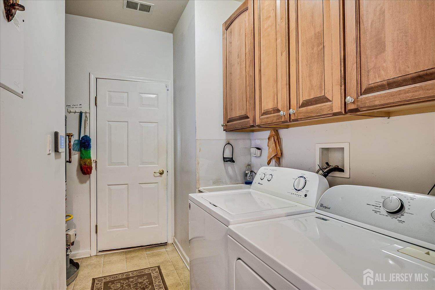 22 Silver Charm Road Manalapan, NJ 07726 - Photo 32 of 51 a utility room with dryer and washer