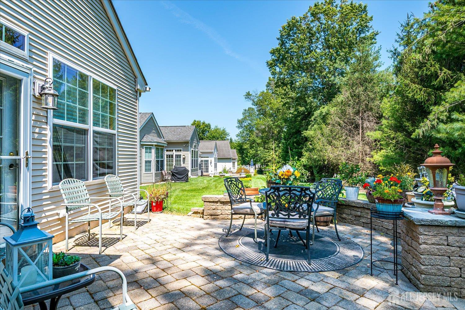 22 Silver Charm Road Manalapan, NJ 07726 - Photo 34 of 51 a swimming pool with outdoor seating and yard