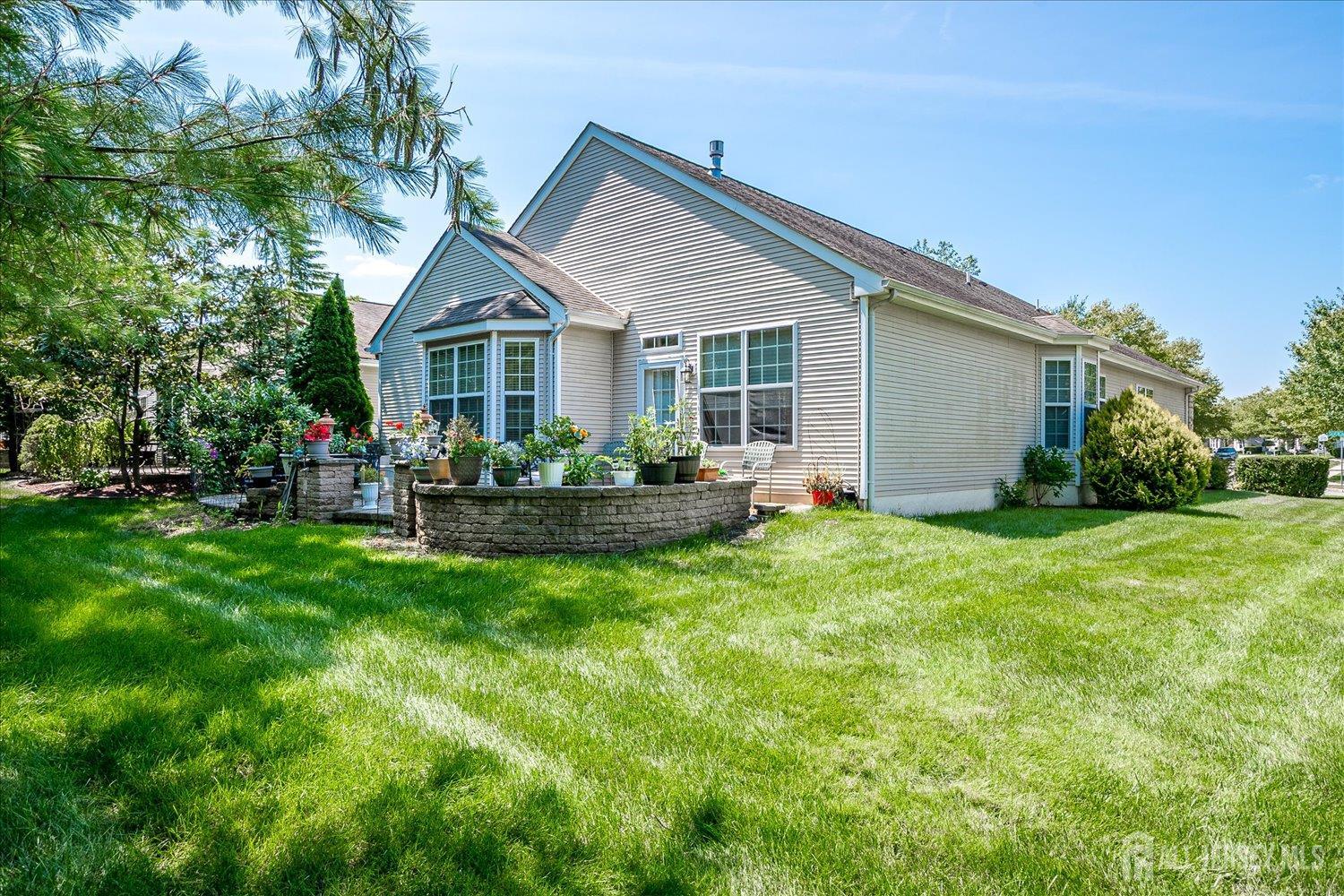 22 Silver Charm Road Manalapan, NJ 07726 - Photo 35 of 51 a view of a house with backyard and garden