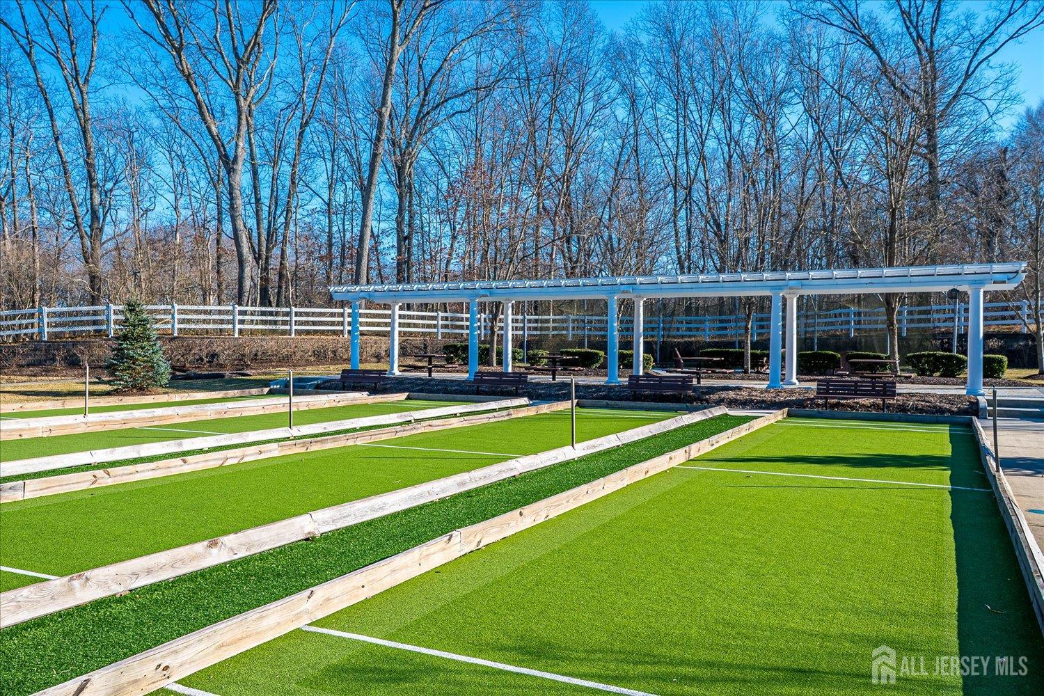 22 Silver Charm Road Manalapan, NJ 07726 - Photo 42 of 51 a view of an house with swimming pool and chairs