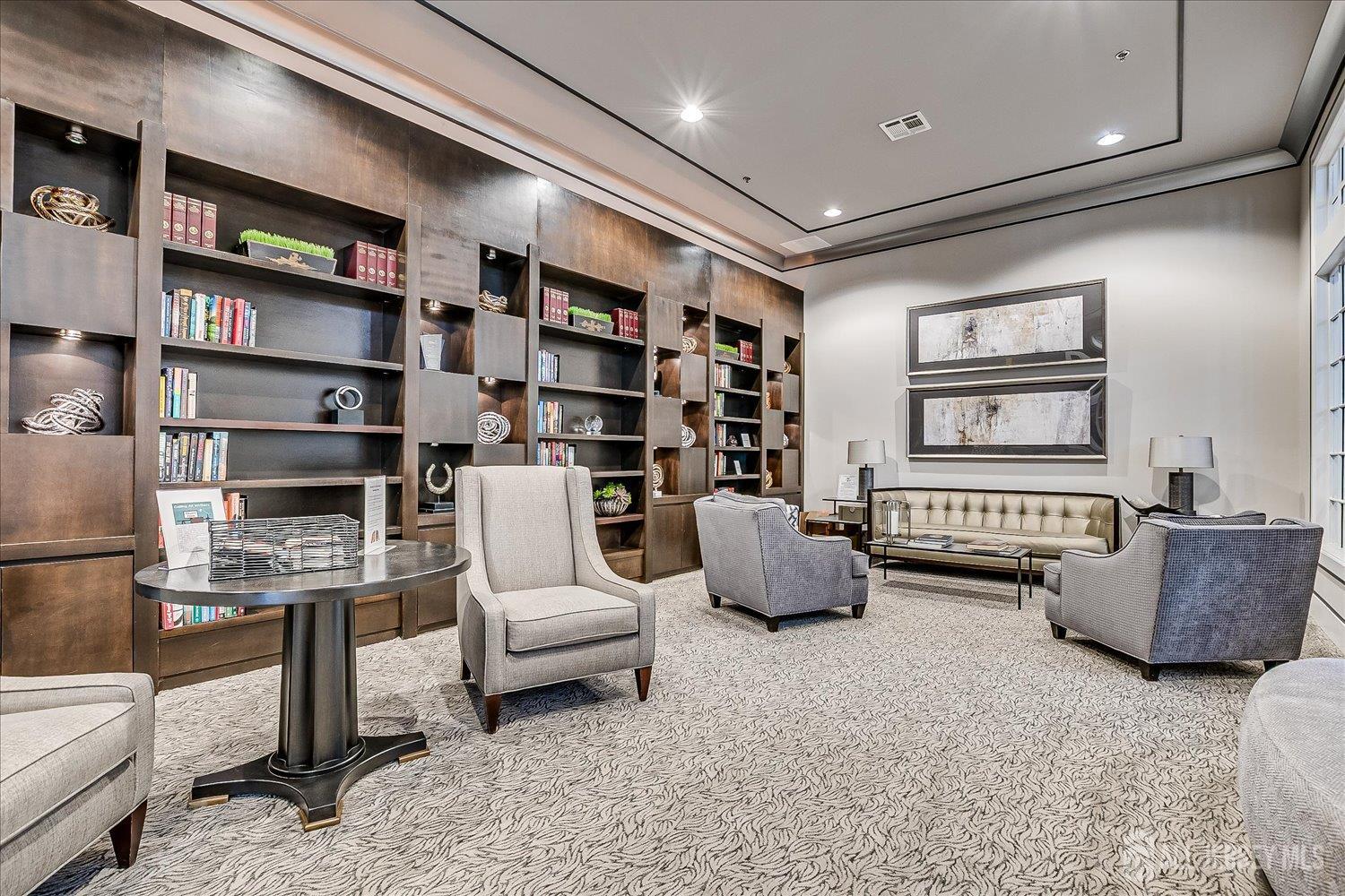 22 Silver Charm Road Manalapan, NJ 07726 - Photo 48 of 51 a living room with furniture and a book shelf