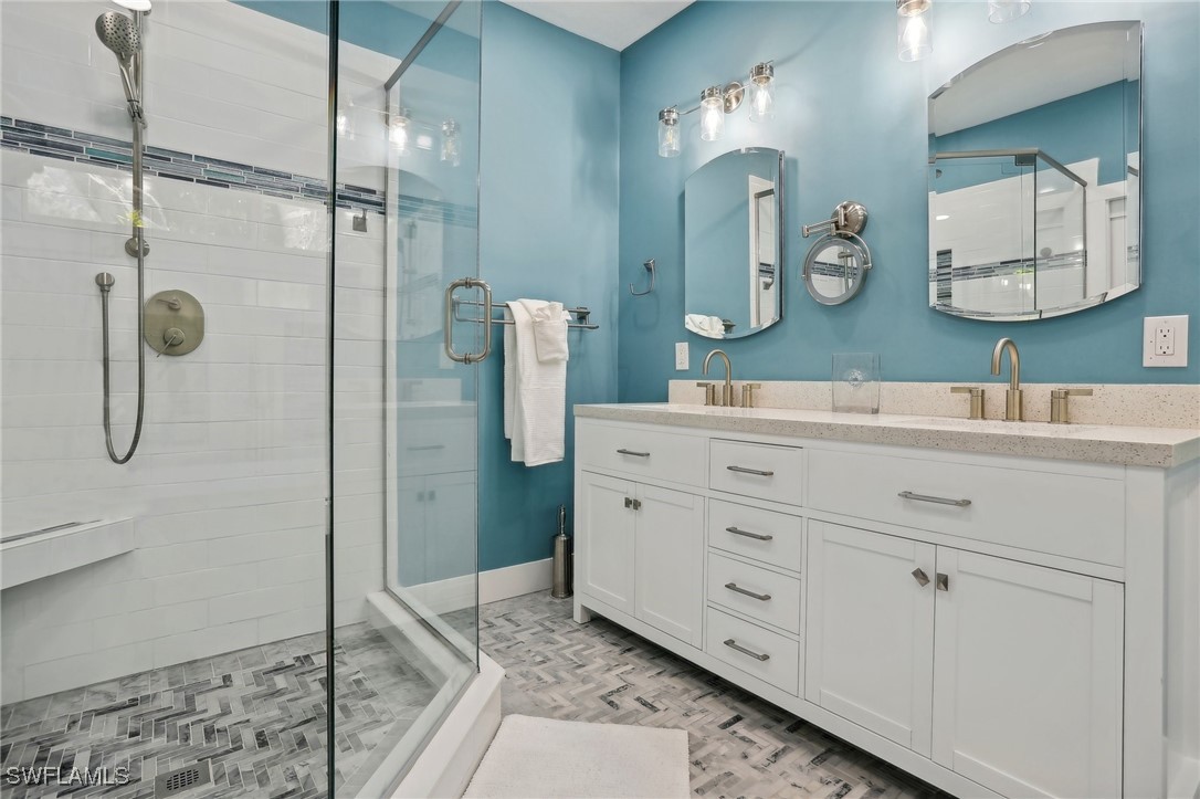 8335 Main Street Bokeelia, FL 33922 - Photo 33 of 47 a bathroom with a double vanity sink and a mirror