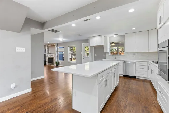 a large kitchen with stainless steel appliances lots of counter top space