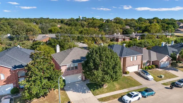 an aerial view of multiple houses with yard