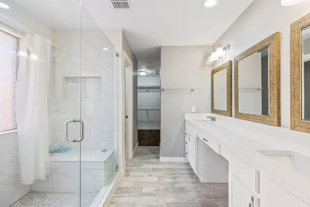 a spacious bathroom with a tub sink and shower