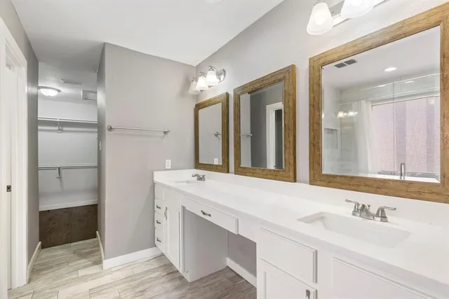 a bathroom with a double vanity sink mirror and double