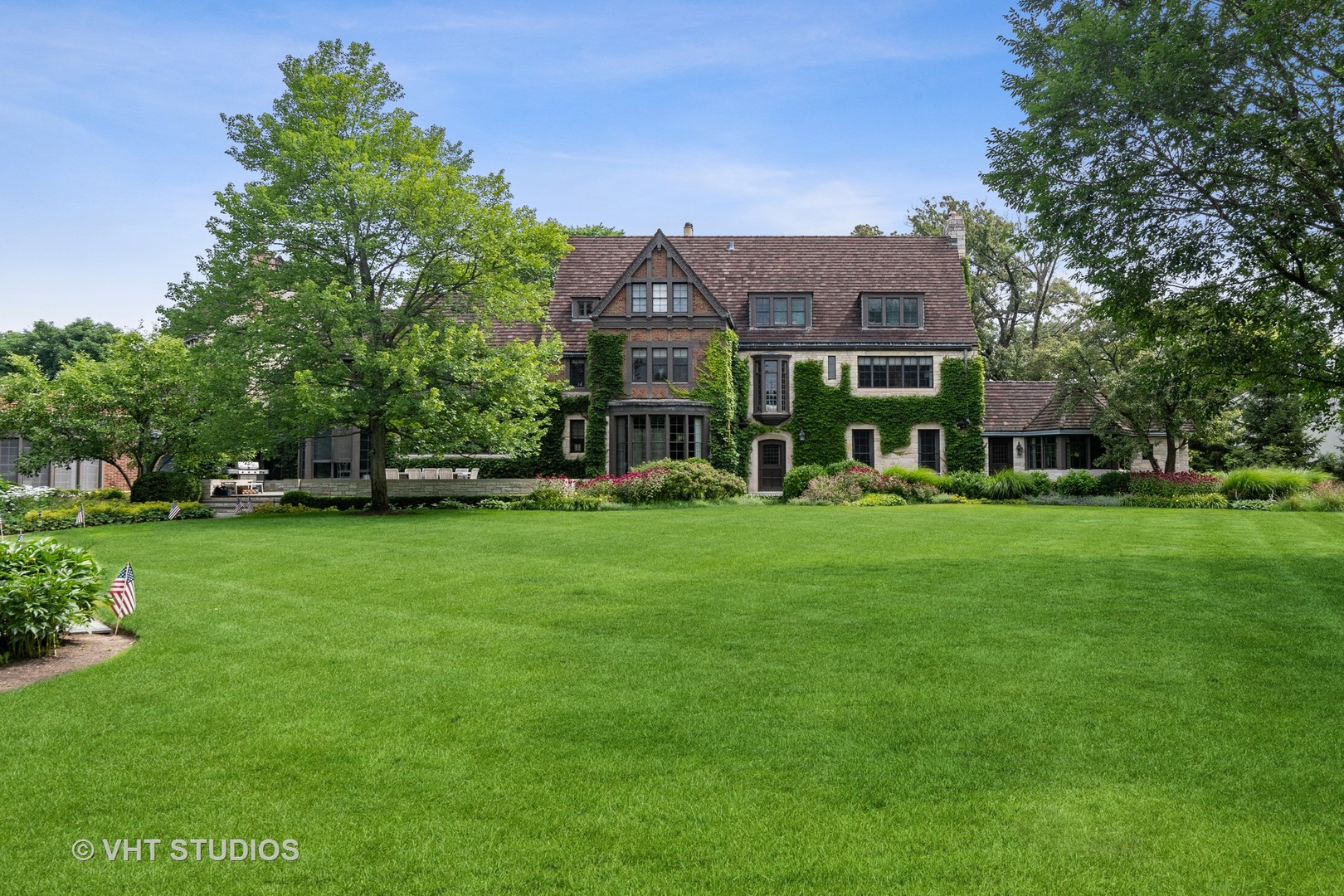 720 Ardsley Road Winnetka, IL 60093 - Photo 12 of 103 a view of a big house with a big yard and large trees