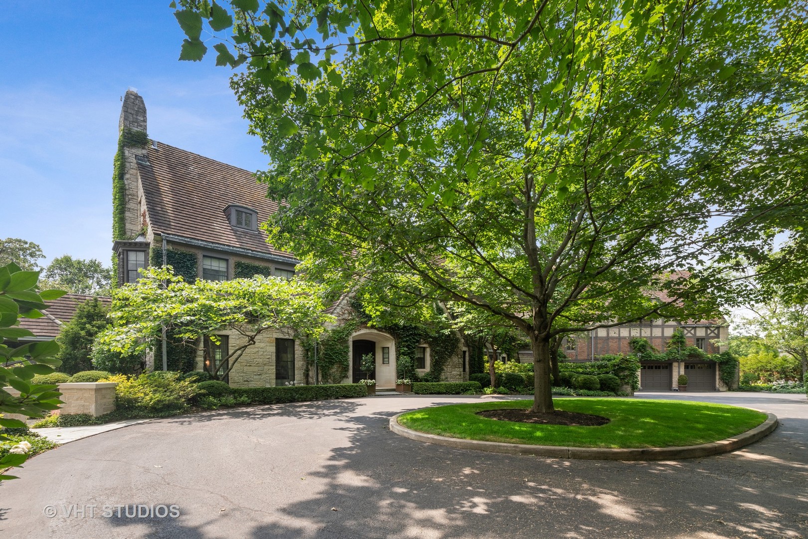 720 Ardsley Road Winnetka, IL 60093 - Photo 6 of 103 a front view of a house with a yard and trees
